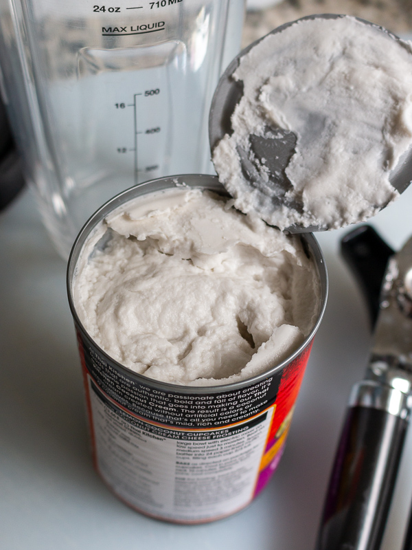 Can of coconut cream showing the coconut cream solids on top.