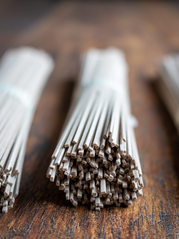 Raw soba noodles in a bundle.