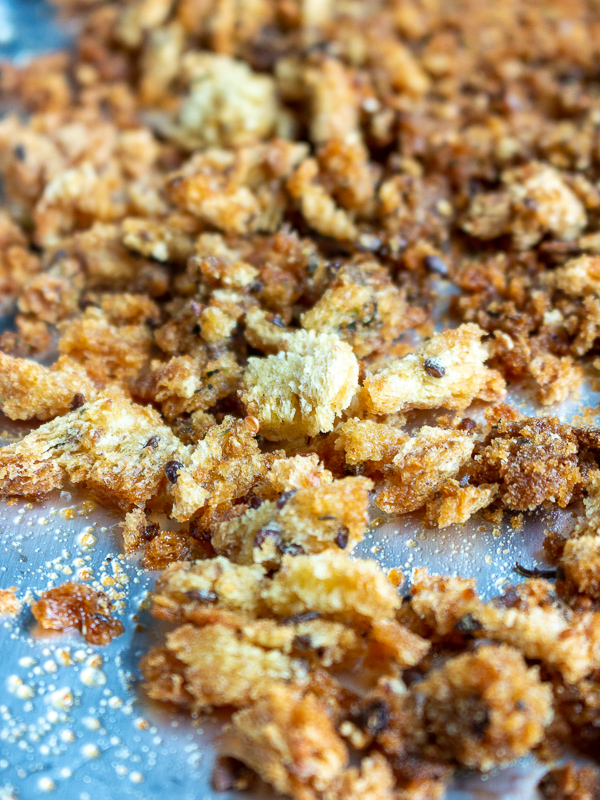 Fresh baked seasoned bread crumbs on the baking sheet.