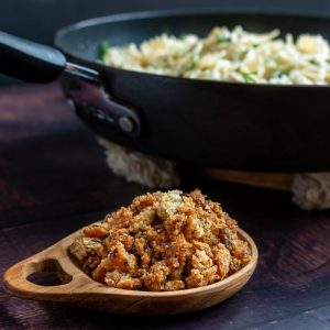 Bowl of homemade Bread Crumbs Next to a skillet of freshly made pasta.