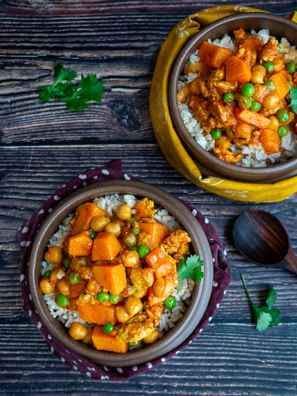 Top down photo of two delicious bowls of prepared ground turkey sweet potato curry.