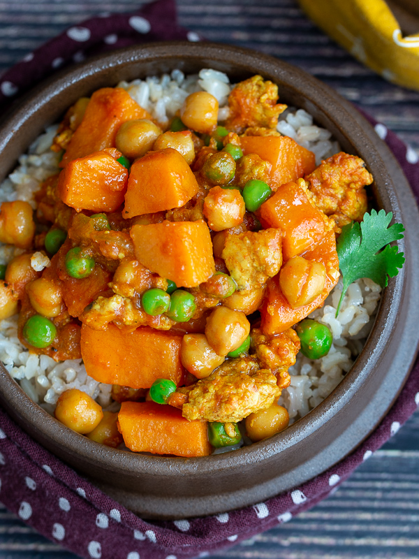 Close up shot top down ground turkey sweet potato curry garnished with parsley. 