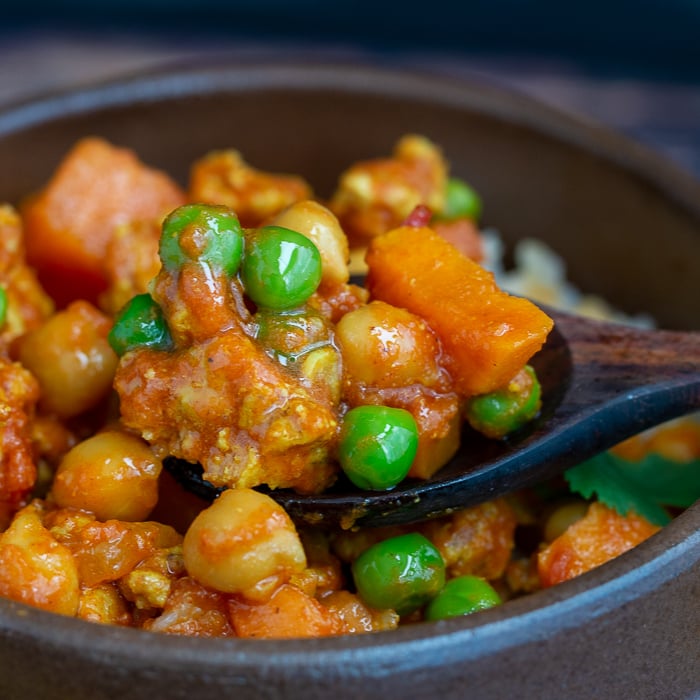 Up close shot with a juicy bite of ground turkey sweet potato curry. 