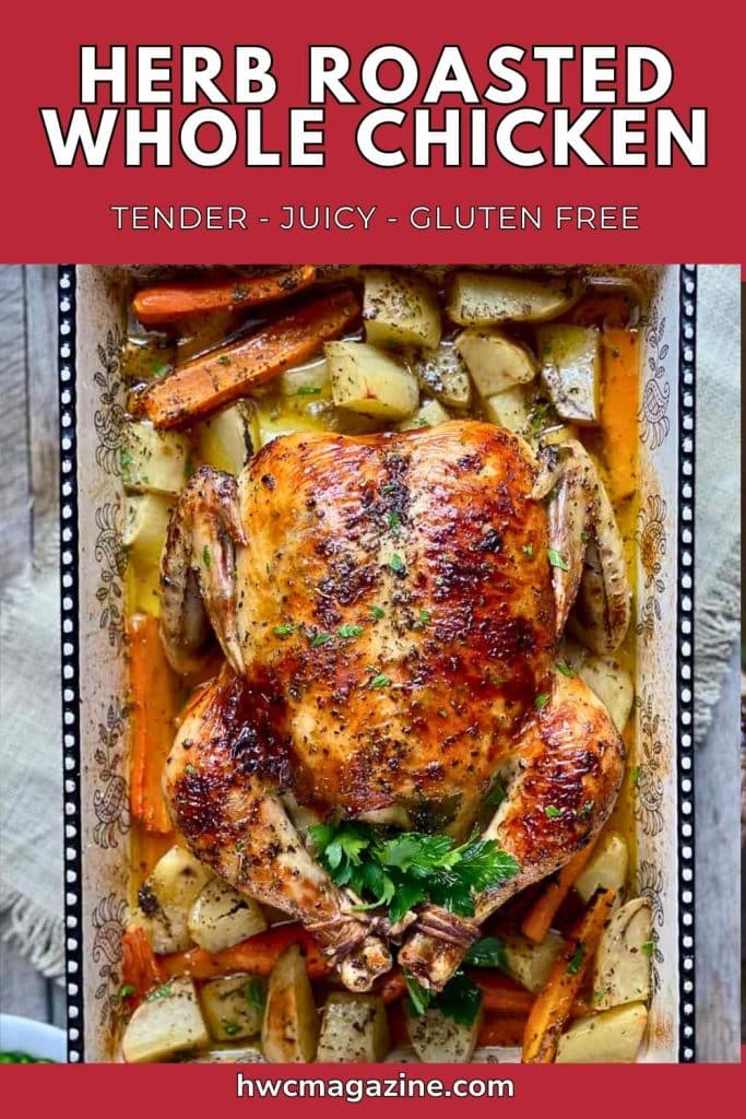 Golden brown crispy skinned chicken in a pan with potatoes and carrots.