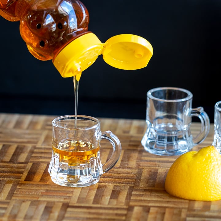 Honey getting poured into the whiskey. 