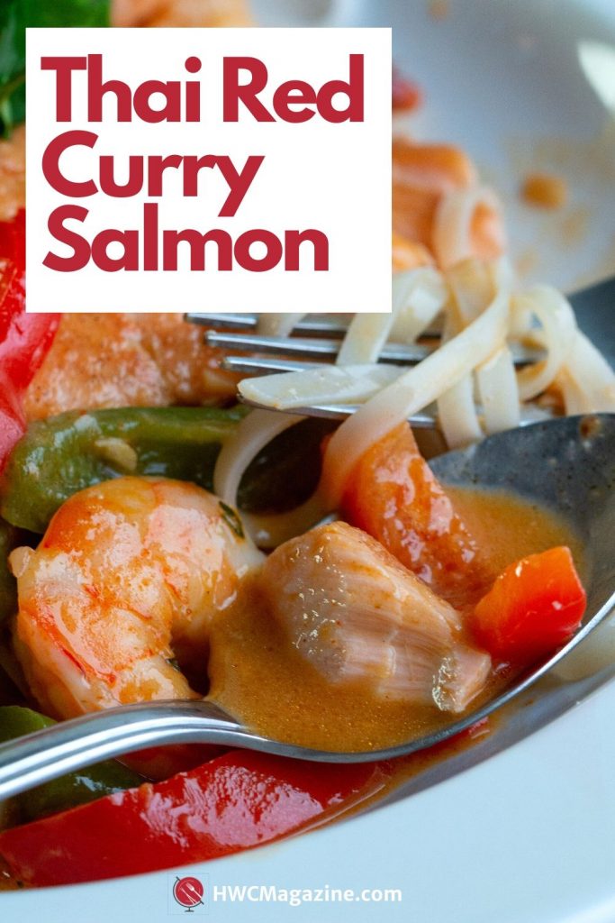 Bowl of thai Red curry salmon with delicious coconut broth in a white bowl with noodles tossed around.