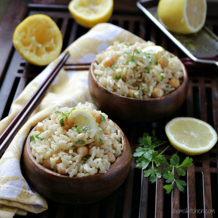 Pantry Recipes for Emergency Preparedness like our Vegan Chickpea Lemon Rice in wooden bowls with sliced lemons around are really satisfying..