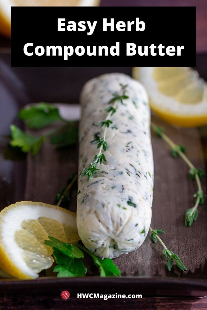 Easy herb compound butter on a black plate with lemons and fresh herbs.