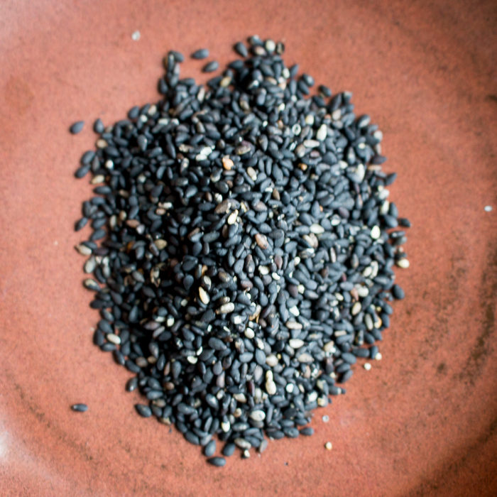 Toasted black sesame seeds in an earthen bowl. 