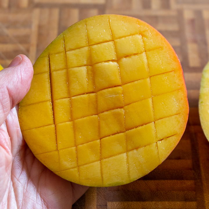 Crisscross cuts on mango half. 