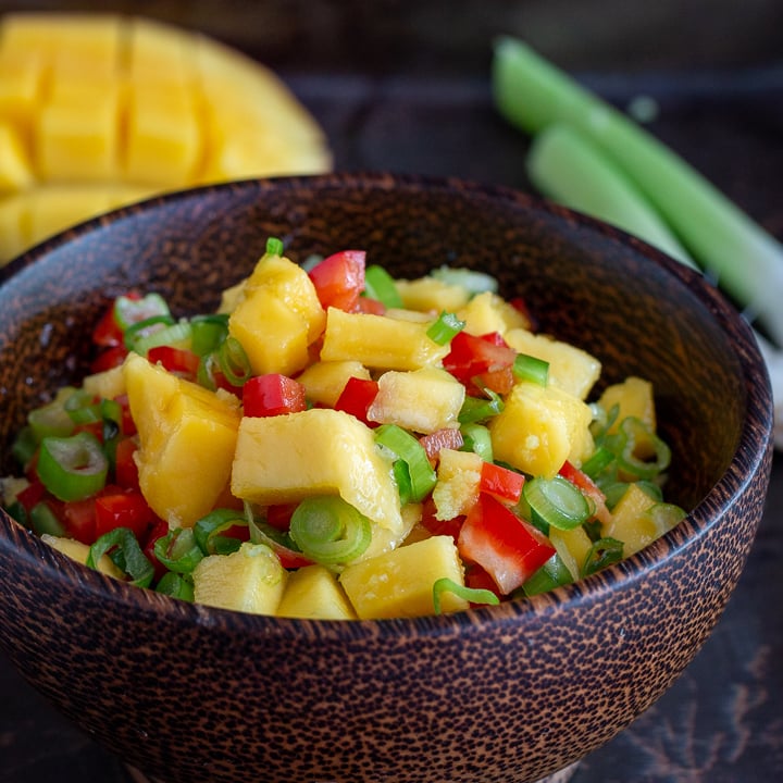 Mango salsa in a wooden bowl.