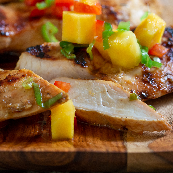 Grilled chicken sliced to show how tender and juicy it is inside.