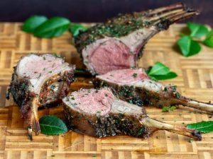 Sliced lamb lollies on a cutting board.