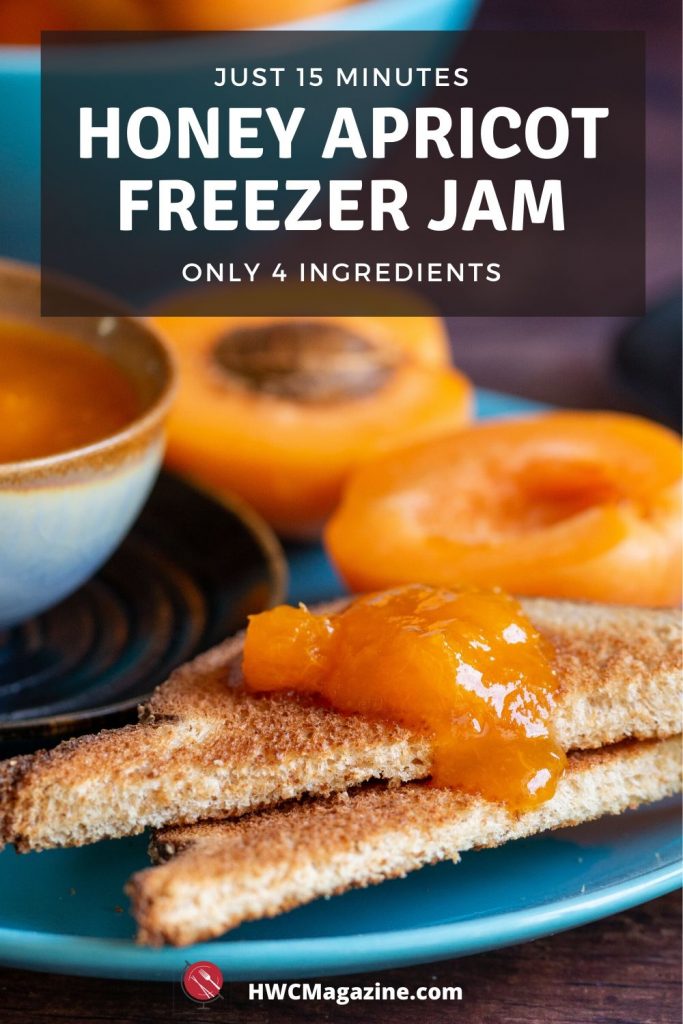 Toast slathered in apricot freezer jam with a bowl of jam next to it and fresh apricots in the background on a turquoise plate.