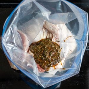 Moroccan marinade poured over the Cornish hen in a bag.