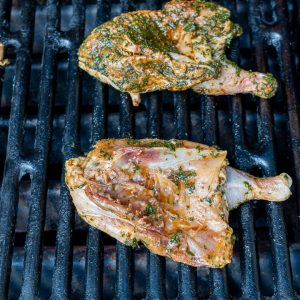 Cornish hens on the grill skin side down.