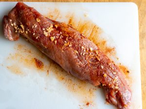 Pork tenderloin has seasoning rubbed on all sides.