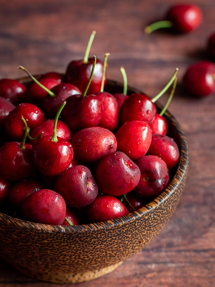 Cherries in a wooden bowl.