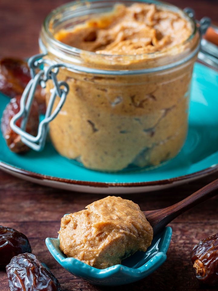 Medjool date paste dollop on a wooden spoon.