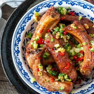 Chinese Style Garlic Ribs topped with fried garlic in a blue and white bowl.