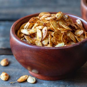 Cajun air fryer pumpkin seeds in a wooden bowl.