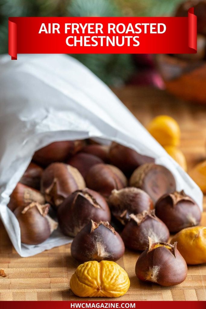 Roasted chestnuts in a white paper bag.