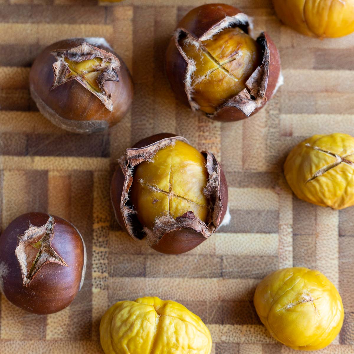 top down shot of roasted air fried chestnuts on a cutting board.