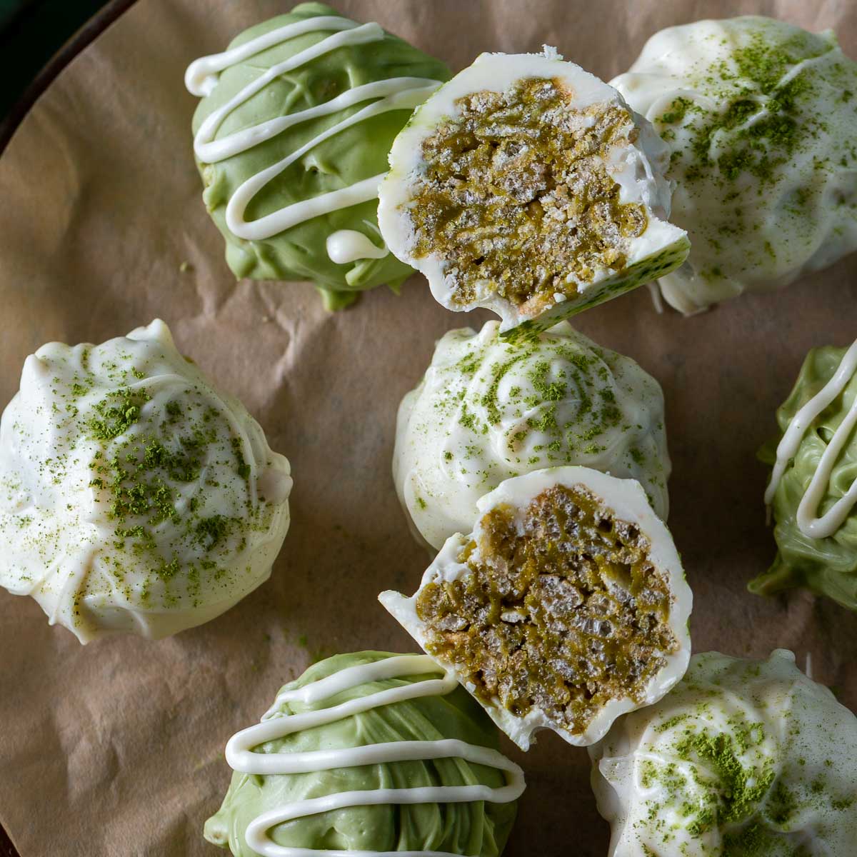 A matcha chocolate truffle cut in half to show the crispy rice center.