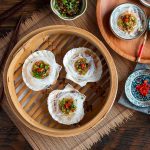 Asian Steamed Scallops with Garlic Vermicelli glass noodles in a Chinese steamer basket.