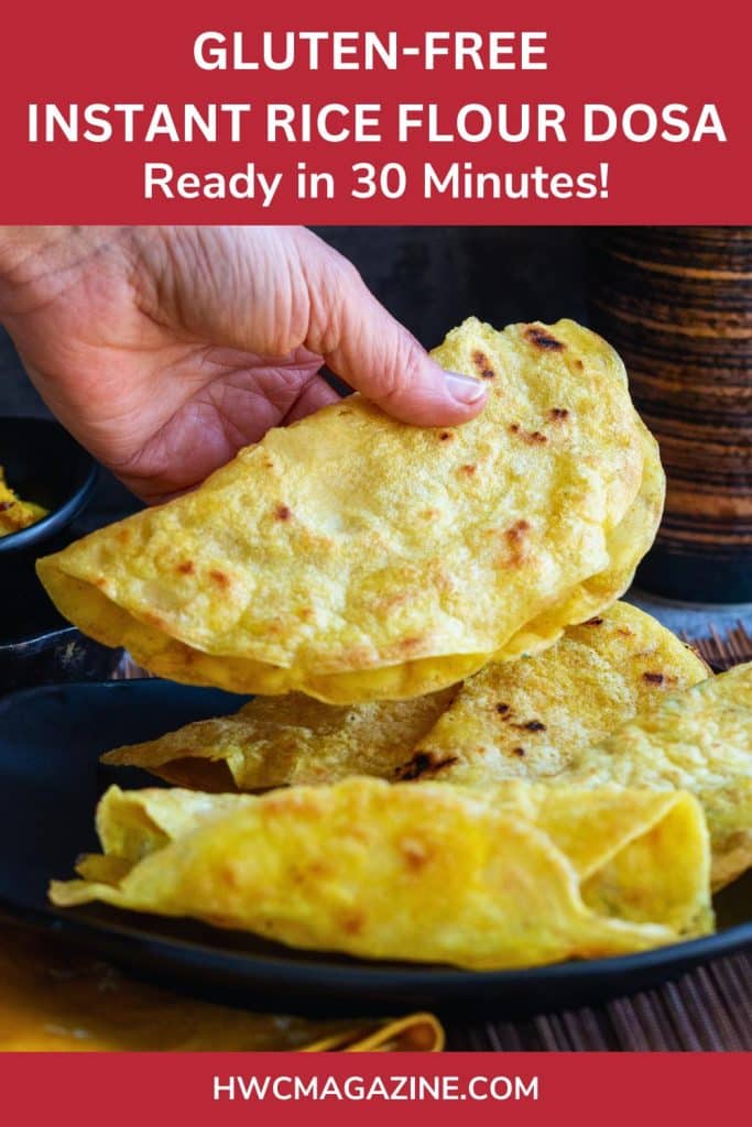 Holding a dosa in hand and a plate of rolled instant dosas cooked and on a black plate.