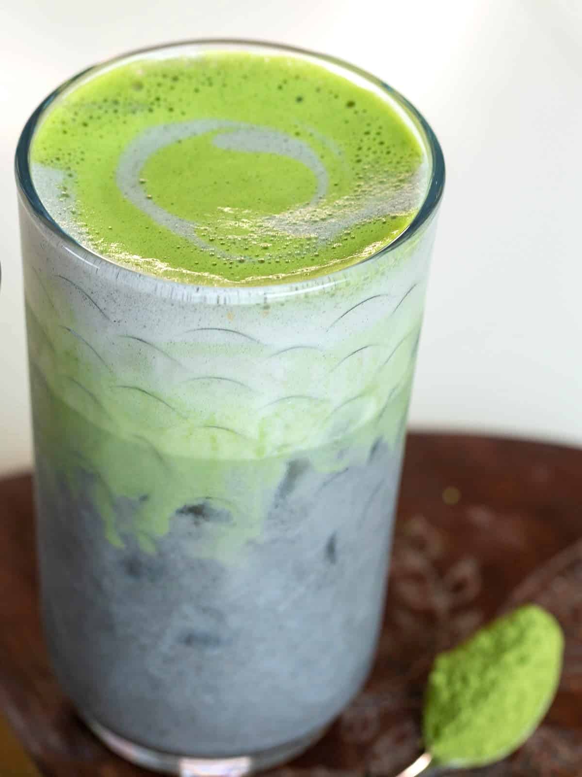 Matcha cold foam on an iced black sesame drink.