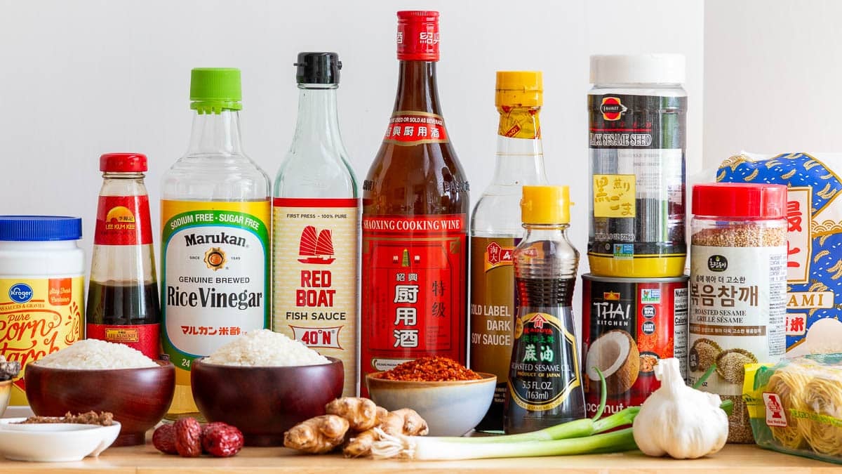 Essential Asian Pantry Staples for the everyday cook all set out on the wooden table. 