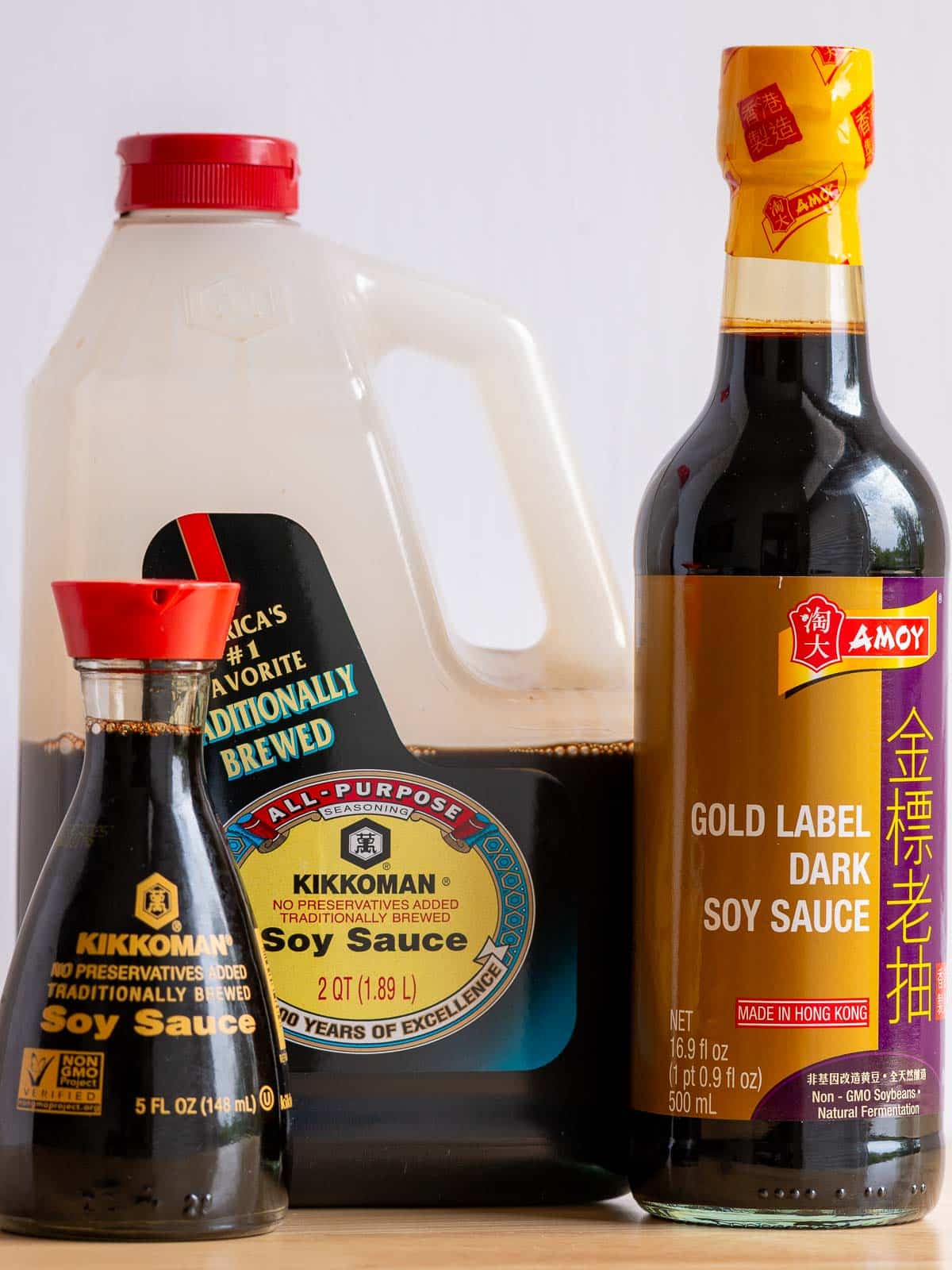 Light traditional soy sauce and dark soy sauce on the wooden table. 