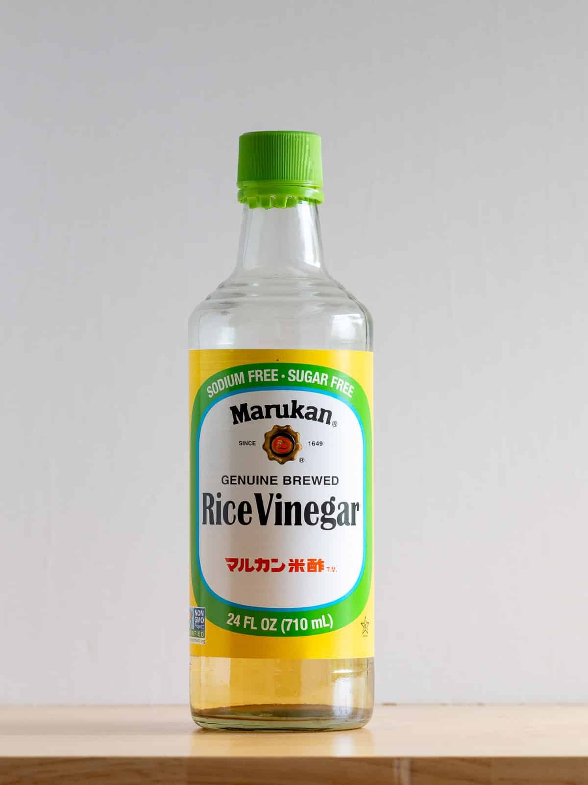 Rice wine vinegar bottle on the wooden counter.