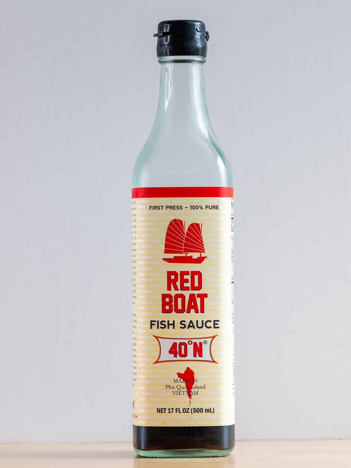 Thai Red Boat fish sauce on a wooden table. 