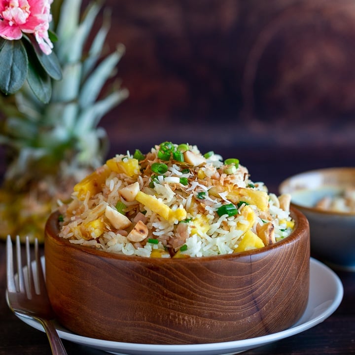 Hawaiian Luau Rice in a wooden bowl with pineapple.