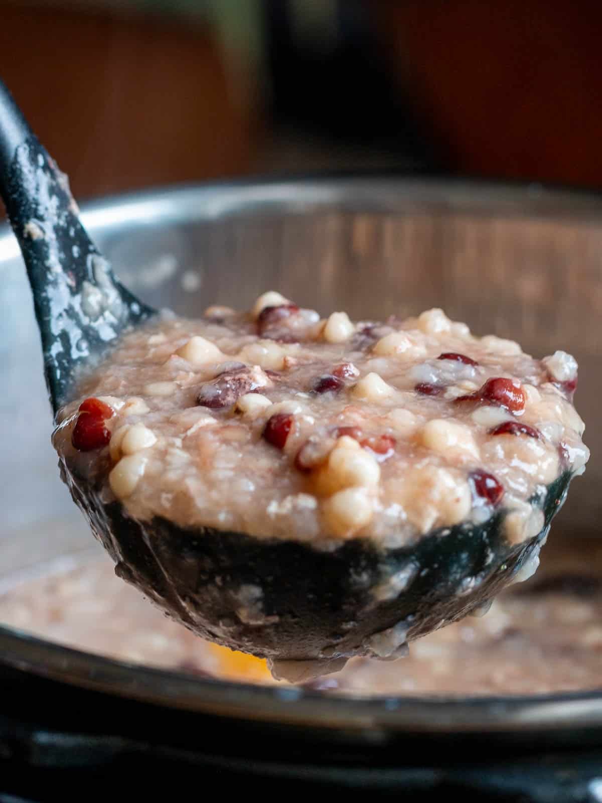 Big soup spoonful of prepared red bean porridge. 