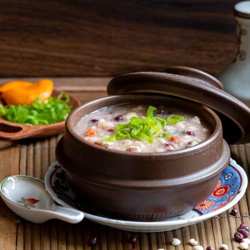 A steaming bowl of Instant pot chicken congee with job's tears, red beans and rice.