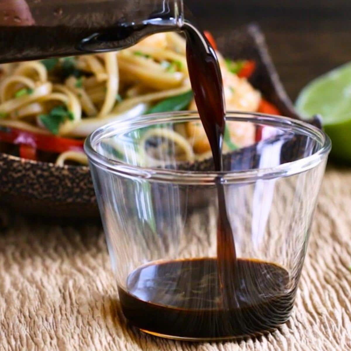 5 Minute homemade Asian noodle sauce getting poured into a glass cup.