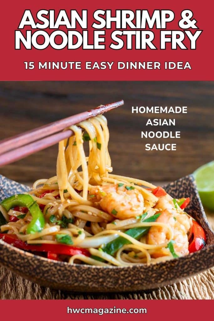 Tossed noodles with shrimp and vegetables held with a pair of wooden chopsticks.
