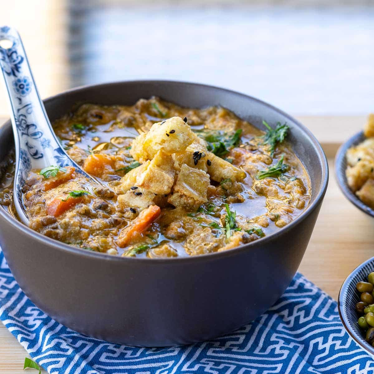 Serving up a hearty bowl of yin nourishing soup super thick and rich in a brown bowl.