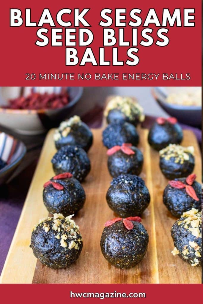 Black sesame seed balls on a wooden board.