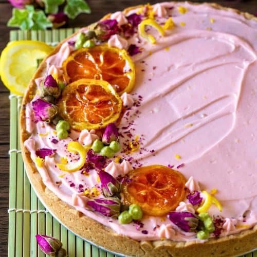 Lemon rose cadamon cookie cake decorated with cream cheese frosting, candied lemons and roses.